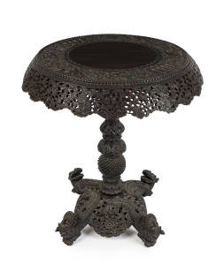 An Anglo-Indian occasional table with ornate carved decoration, 19th century, 74cm high, 66cm diameter