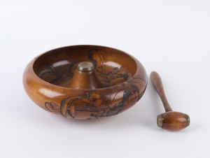A pokerwork nut bowl and nutcracker made from Tasmanian huon pine, circa 1920, 22cm diameter