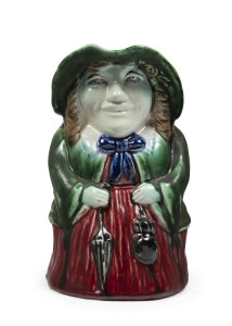 MELROSE WARE female toby jug glazed in green and red, factory mark partially legible. 18cm high