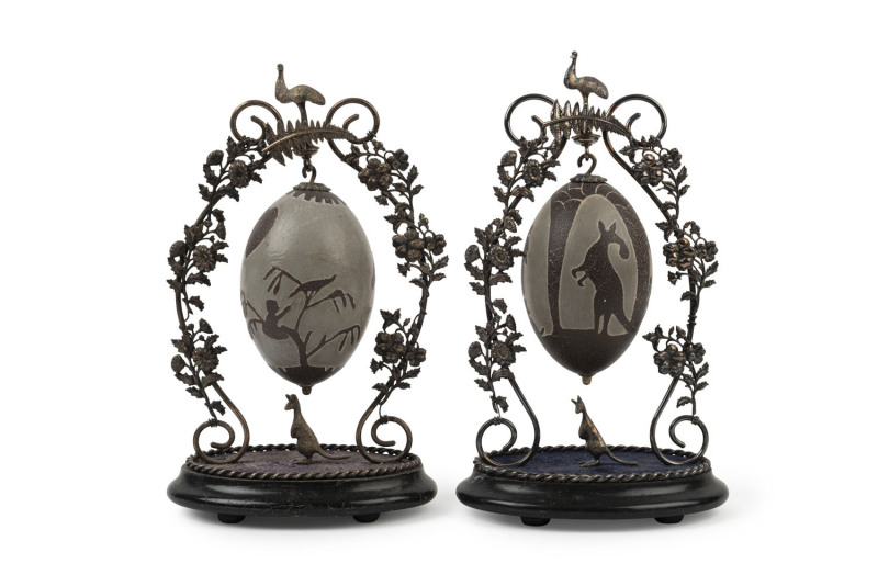 A pair of carved emu eggs on Australian silver plated stands, 19th century, ​31cm high