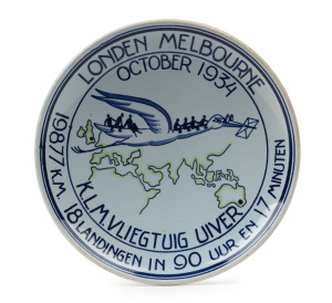 THE LONDON to MELBOURNE, MacROBERTSON CENTENARY AIR RACE 1934 Porcelain hanging plaque by Koninklyk Goedewaagen Gouda (and numbered "3" on reverse), 18.5cm diameter; depicting a stork (Uiver in Dutch) carrying passengers and mail over the route from Londo