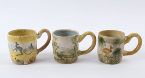 ARTHUR MERRIC BOYD & NEIL DOUGLAS: Three pottery mugs painted with kangaroos in landscape, all with yellow handles, incised "A.M.B.", ​the largest 9.5cm high, 13cm wide