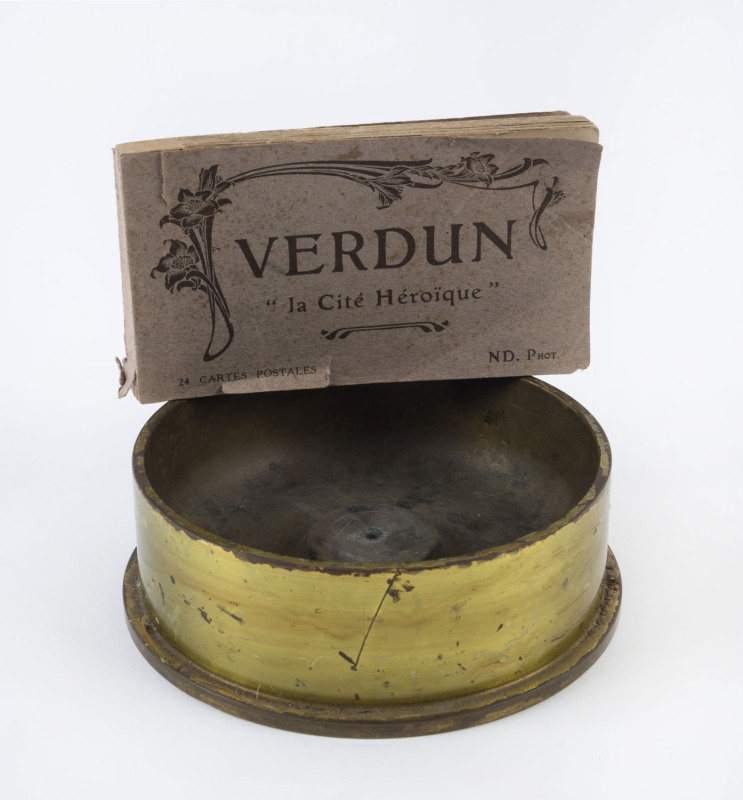 A trench art bowl made from a WW1 shell, together with a booklet of 24 WW1 postcards "VERDUN", (2 items), the bowl 16.5cm diameter