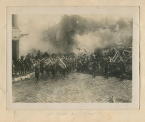 Herbert F. Baldwin (Brit.,1880-1920). The Band of the 5th Australian [Infantry Brigade]… Passing Through The Grande Place At Bapaume, France silver gelatin photograph of an Australian military band marching through a devastated street, mounted on album pa