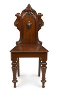 An Australian cedar hall chair with carved shield back, circa 1875, ​94cm high