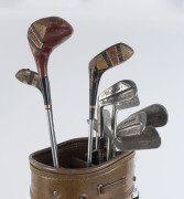 Bag of well-travelled golf clubs, comprising seven irons, putter, 2-Wood and two 4-Woods, various manufacturers, plus Korean made vinyl & leather golf bag. - 2