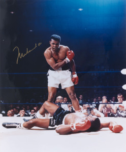 MUHAMMAD ALI: colour photograph of Ali (41x51cm) standing over a vanquished Sonny Liston, SIGNED BY ALI in gold pen.