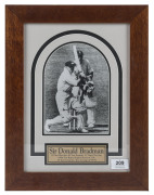 "Bradman watches the ball race to the boundary", attractively framed photograph, signed by Bradman (in ink) with his career details on a plaque below. Overall 40.5 x 31cm.