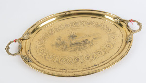 FROM HYDERABAD to NEW ZEALAND: A large brass tray with central vignette engraving of a desert encampment, with camels waiting and guests being welcomed under a tent for a meal; with engraved testimonial "Presented to J.E. Yates Esq'r, Manager, by the Offi