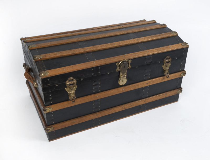 A domed top cabin trunk by Pocknall & Hosking of Fitzroy, Melbourne, interior fitted with blue cloth lift-out compartments, exterior bound in Tasmanian oak and brass, 19th century, 49cm high, 94cm wide, 54cm deep