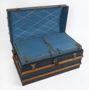 A domed top cabin trunk by Pocknall & Hosking of Fitzroy, Melbourne, interior fitted with blue cloth lift-out compartments, exterior bound in Tasmanian oak and brass, 19th century, 49cm high, 94cm wide, 54cm deep - 2