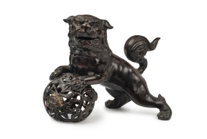 A Chinese cast metal Foo dog statue with bronze finish, 20th century, 32cm high, 42cm wide