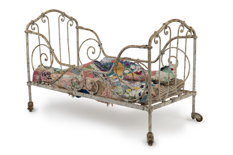 A salesman's sample folding iron bed with original mattress and additional quilt, 19th century, 37cm high, 56cm wide, 27cm deep