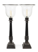 A pair of GERALDINE COOPER candle holders, black marble and bronze with glass shades, late 20th century. Original purchase price in 1997 $1,330. 71cm high