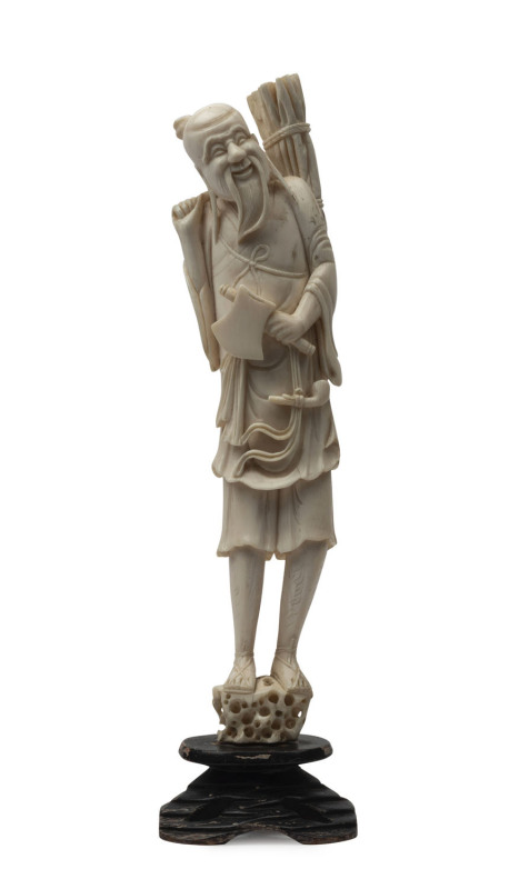 A Japanese carved ivory statue of a wood cutter, Meiji period, ​31.5cm high, 35.5cm high overall