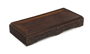 A Chinese carved hardwood stand, Qing Dynasty, early 19th century, 5cm high, 31cm wide, 13.5cm deep