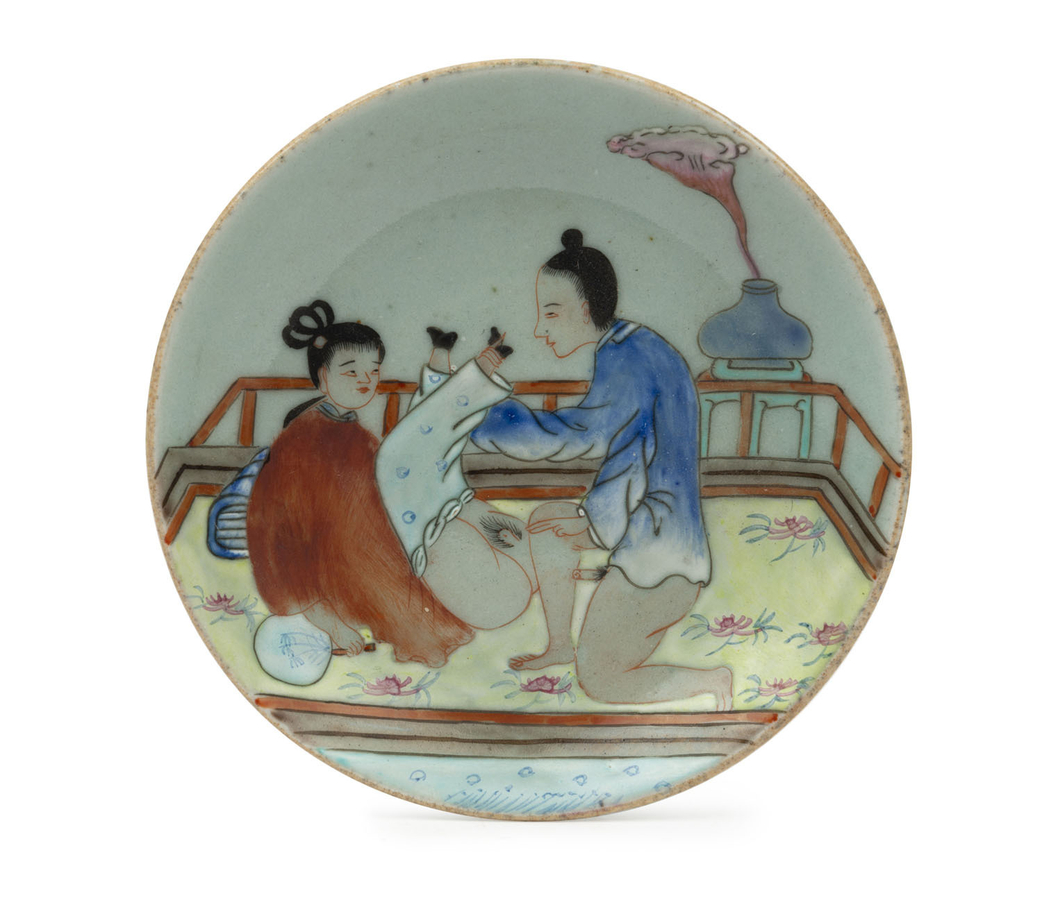 A Chinese celadon dish with enamel erotic scene decoration, Qing Dynasty,  19th century, ​13.5cm