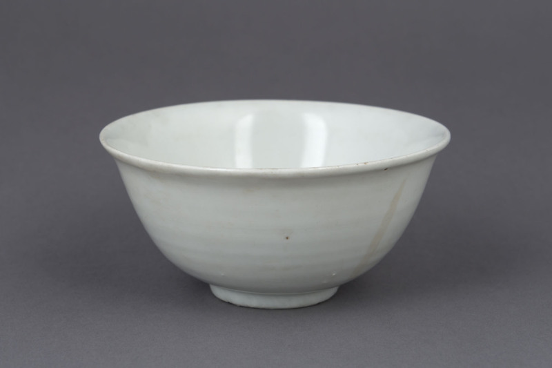 A Chinese blanc de chine porcelain tea bowl, 18th century, ​5cm high, 11.5cm diameter