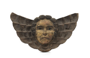 A cherub wall plaque, carved wood with polychrome finish, 18th/19th century, ​31cm wide