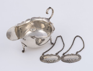 An English sterling silver sauce boat made in Chester, circa 1924; together with a pair of sterling silver decanter labels stamped 925, (3 items), the jug 14c, wide, 110 grams total