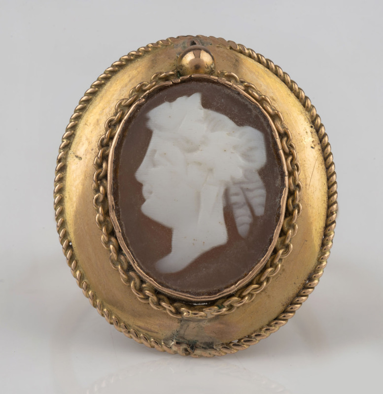 An antique cameo portrait ring set in 15ct gold, stamped "15" flanked by pictorial marks (illegible), ​2.3cm high