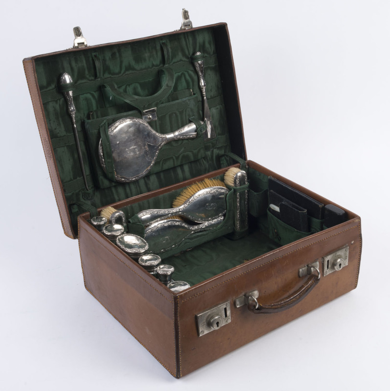 A sterling silver antique travel set in original leather case, retailed through W.E. JACKSON "The Bag Store" Nottingham, circa 1907, ​the case 43cm wide