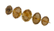 An antique rose gold bar brooch set with five large yellow topaz stones, circa 1900, ​5.5cm wide, 11.9 grams total