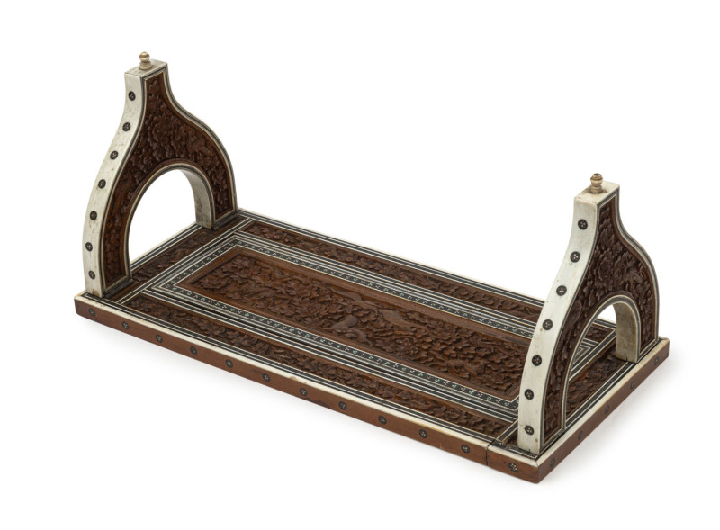 An Anglo-Indian book stand, carved sandalwood and bone inlaid with silver and ebony, 19th century, ​14cm high, 31cm wide