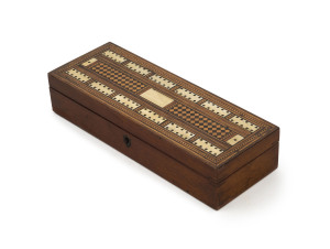 An English cribbage topped games box, walnut inlaid with rosewood, ivory and satinwood, 19th century, interior fitted with compartments, 6cm high, 28cm wide, 10cm deep