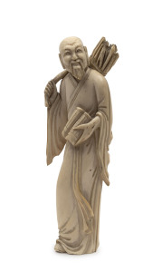 A Chinese carved ivory statue of a man carrying a bundle of sticks, 19th century, 15cm high
