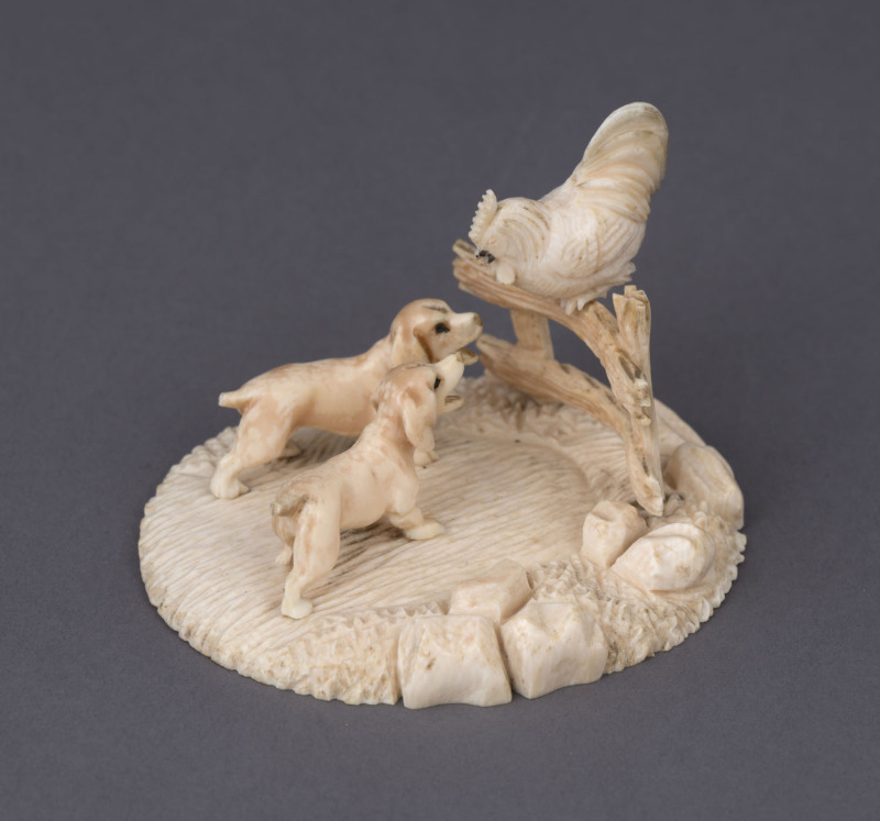 A Dieppe carved ivory figural group with a cockerel and two hounds, 19th century, ​6cm high, 9cm wide