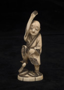 A Japanese carved ivory statue of a man and a snake, Meiji period, early 20th century, 10.5cm high