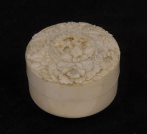 A Japanese circular box, finely carved ivory with chrysanthemum decoration, Meiji period, ​4cm high, 6.5cm diameter