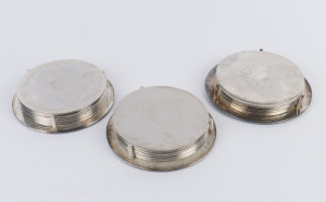 Set of 18 silver plated place mats in original cradles, mid 20th century, (21 items), 19.5cm diameter