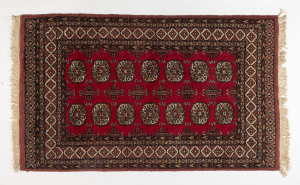 A Pakistani red patterned tribal rug, 20th century, 165 x 93cm