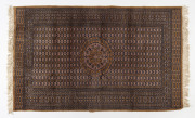 A Turkomen pink and gold coloured hand-knotted rug, 20th century, ​160 x 93cm