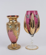 An Italian ruby glass goblet and vase, both with enamel floral decoration and gilded highlights, mid 20th century, (2 items), ​34cm and 30cm high