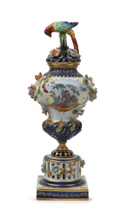 An Italian porcelain mantel urn decorated with finely applied flowers and parrot finial, 20th century, 43cm high