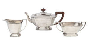 An English sterling silver three piece tea service made in Birmingham, circa 1936, the teapot 15cm high, 29cm wide, 1,190 grams total