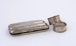 A sterling silver triple cigar case with gilt wash interior together with two silver napkin rings, 19th and early 20th century, (3 items), cigar case 13cm long, 157 grams total