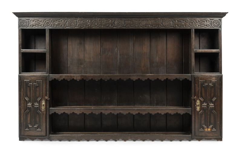 An English West Country kitchen dresser back, stained oak, 18th century, 118cm high, 194cm wide, 22cm deep