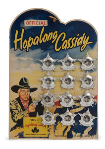 DCMT LTD - Hopalong Cassidy Badges - Shop Display: c.1950s evocatively illustrated shop display card, with the 12 original badges intact, the badges with paper inserts showing actor William Boyd portraying Cassidy, overall 25x36mm.