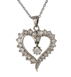 A 14ct white gold love heart pendant set with 25 brilliant cut graduated diamonds with single emerald cut diamond in the centre, stamped "585, 14ct", on a silver chain, 2.5cm high, pendant weight 4.7 grams