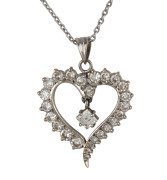 A 14ct white gold love heart pendant set with 25 brilliant cut graduated diamonds with single emerald cut diamond in the centre, stamped "585, 14ct", on a silver chain, 2.5cm high, pendant weight 4.7 grams