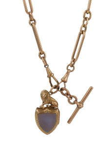 An antique 9ct rose gold fob chain with shield shaped locket inlaid with stone adorned with lion finial, 19th century, 48cm long, total weight 57.5 grams