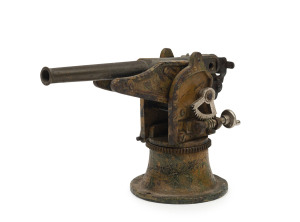 MARKLIN: - Anti-Aircraft Gun: cast iron with brass gun barrel, gun elevation controlled by the turning the handle of a geared brass mechanism, camouflaged carriage, faded 'MARKLIN' stamp on carriage plate; c.1930s, length 12cm, height 10cm, weight 480g.