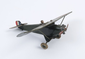 BRITAINS: - Monoplane: pre-war propeller-driven monoplane, green livery, with French colours on tail fin, detachable seated pilot, stamped on base 'MADE IN ENGLAND/BY/BRITAINS LTD/LONDON'; c.1950s, length 15cm, wingspan 22.5cm.