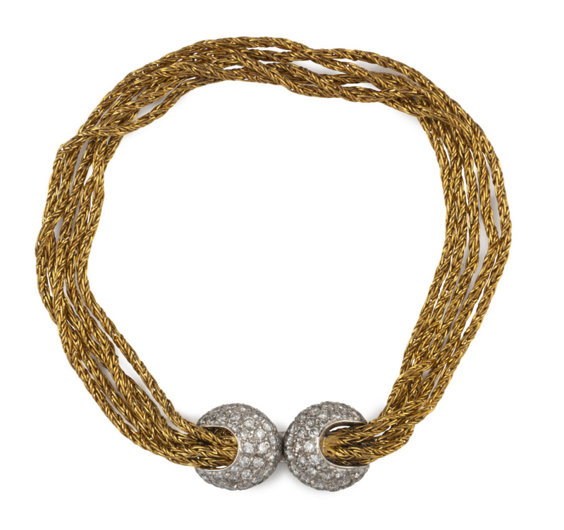 An 18ct yellow gold five strand bracelet adorned with diamond pave set white gold roundels, stamped "750, W. Germany", 14.5 grams