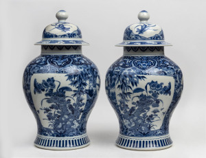 An impressive pair of Chinese porcelain vases and covers finely decorated in underglaze blue depicting precious objects and foliage, late Qing Dynasty, 19th century, 49cm high