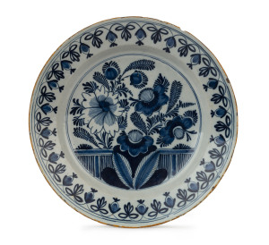 A Dutch Delft platter decorated with flowers and foliage, circa 1770, 35cm diameter